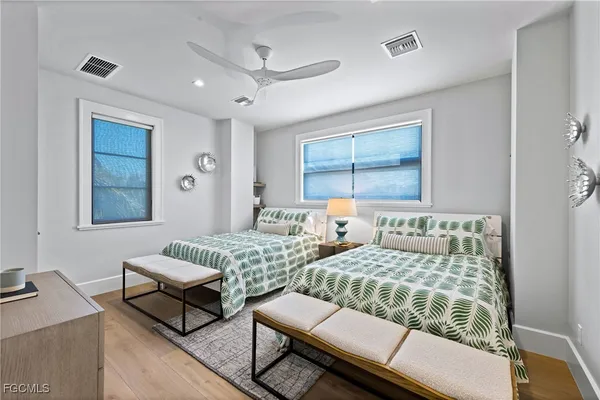 a bedroom with two beds and a table