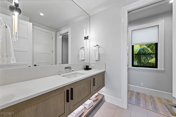 a bathroom with a double vanity sink and a mirror