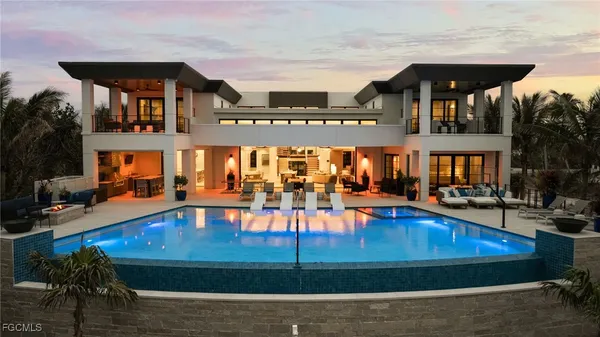 a view of a swimming pool with outdoor seating