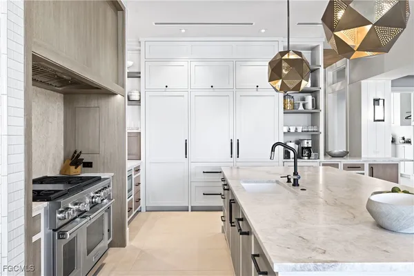 a kitchen with a sink appliances and cabinets