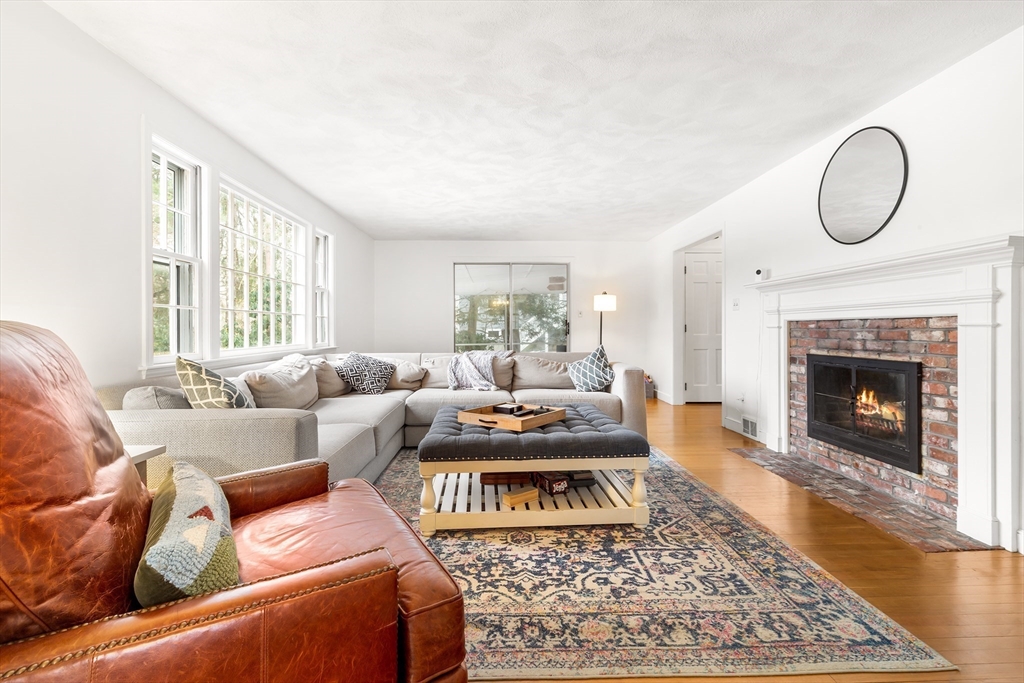 14 Griscom Road Sudbury, MA 01776 - Photo 2 of 32 a living room with furniture a rug a fireplace and a window