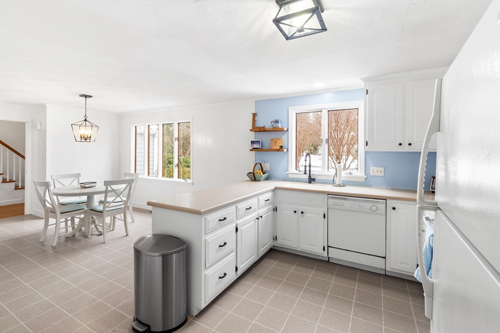 14 Griscom Road Sudbury, MA 01776 - Photo 8 of 32 a kitchen with granite countertop cabinets a sink a window and stainless steel appliances