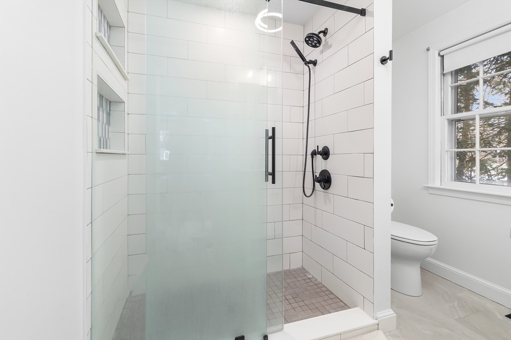 14 Griscom Road Sudbury, MA 01776 - Photo 10 of 32 a bathroom with a shower a toilet and a window
