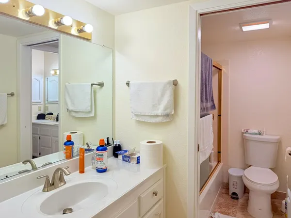 a bathroom with a sink toilet and mirror
