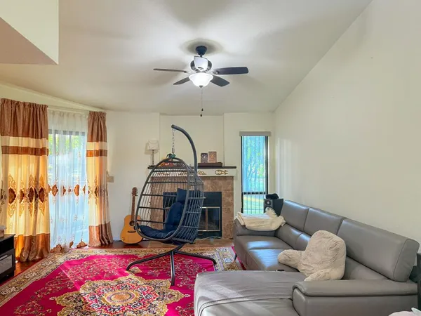 a living room with furniture a rug and a chandelier