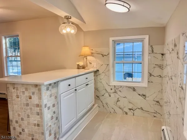 a bathroom with a sink a vanity and a shower