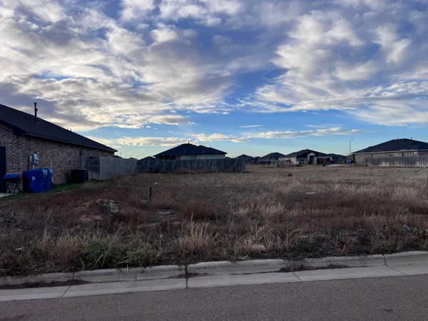 a view of a house with a yard and mountain view