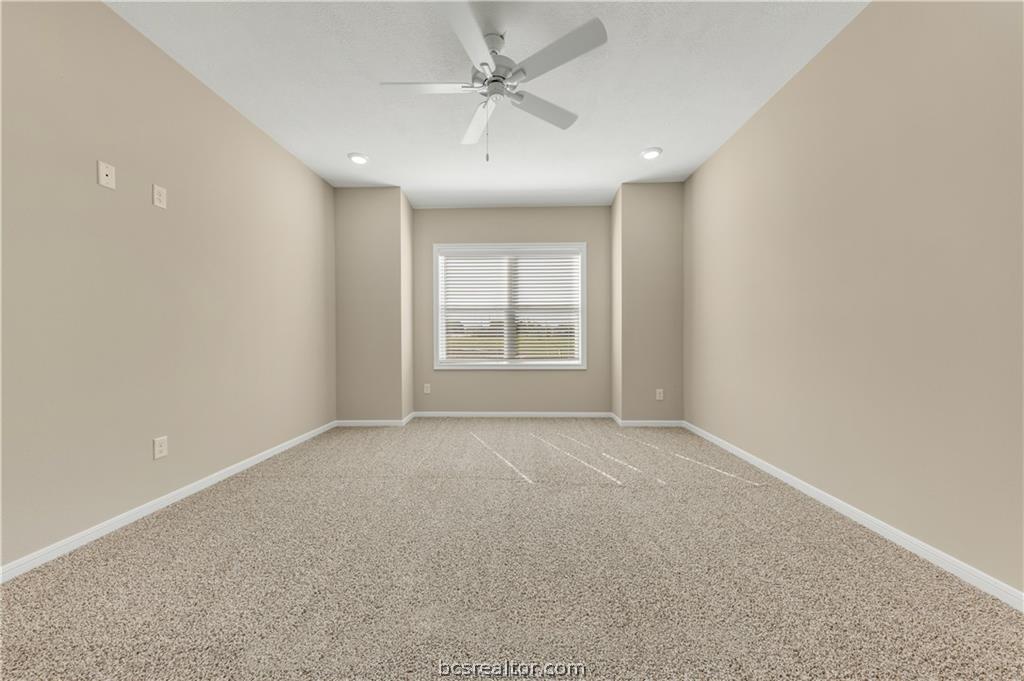 1249 Storm Row Lane Bryan, TX 77803 - Photo 11 of 20 an empty room with windows and ceiling fan