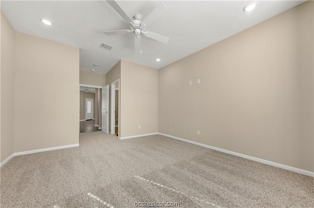 1249 Storm Row Lane Bryan, TX 77803 - Photo 12 of 20 an empty room with a ceiling fan and a bathroom