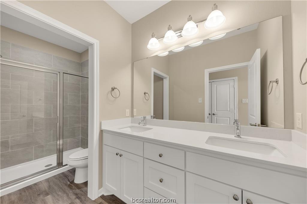 1249 Storm Row Lane Bryan, TX 77803 - Photo 13 of 20 a bathroom with a shower a sink and mirror