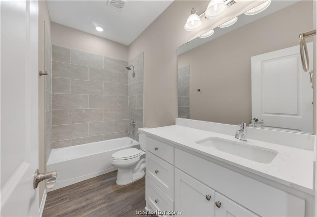 1249 Storm Row Lane Bryan, TX 77803 - Photo 14 of 20 a bathroom with a sink a toilet a mirror and shower