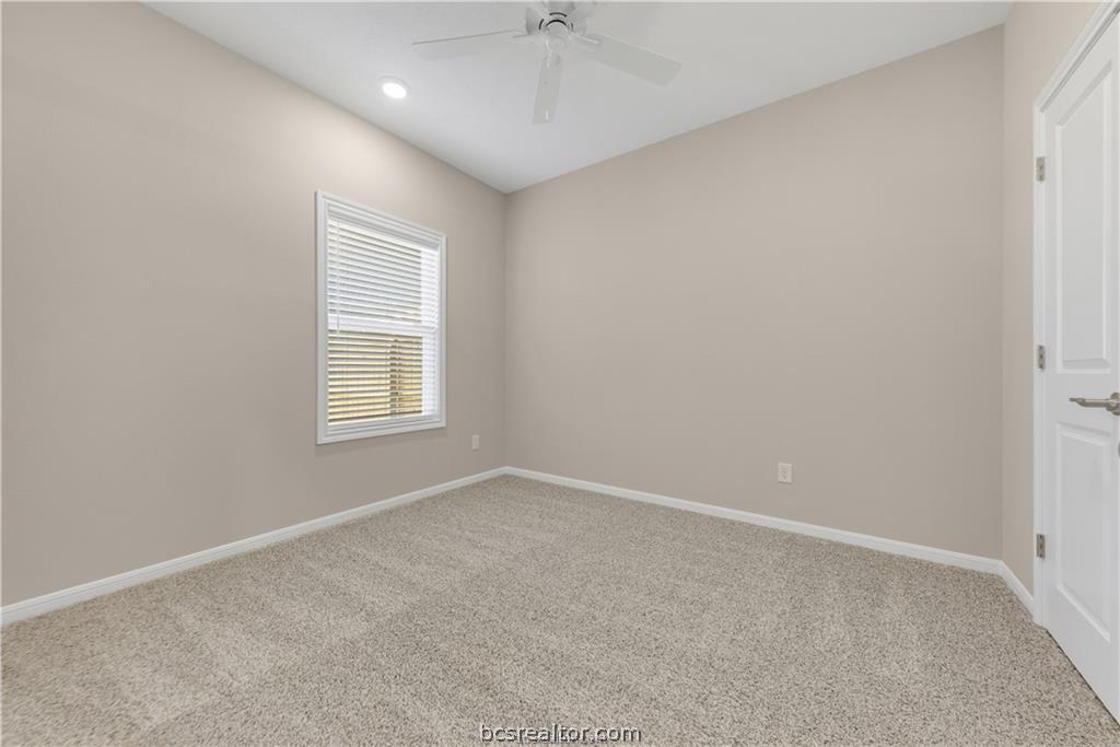 1249 Storm Row Lane Bryan, TX 77803 - Photo 15 of 20 an empty room with windows and fan