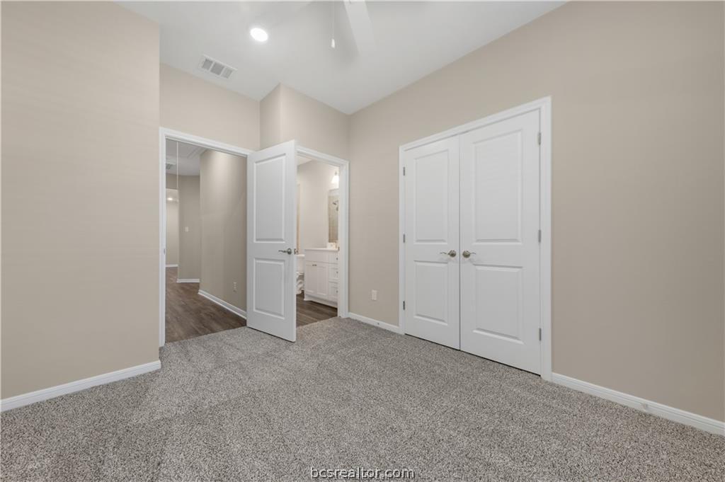 1249 Storm Row Lane Bryan, TX 77803 - Photo 17 of 20 an empty room with an entryway and white doors