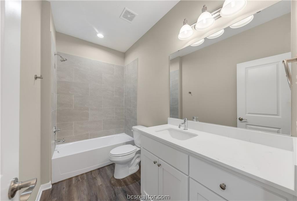 1249 Storm Row Lane Bryan, TX 77803 - Photo 18 of 20 a bathroom with a sink a toilet and a bathtub