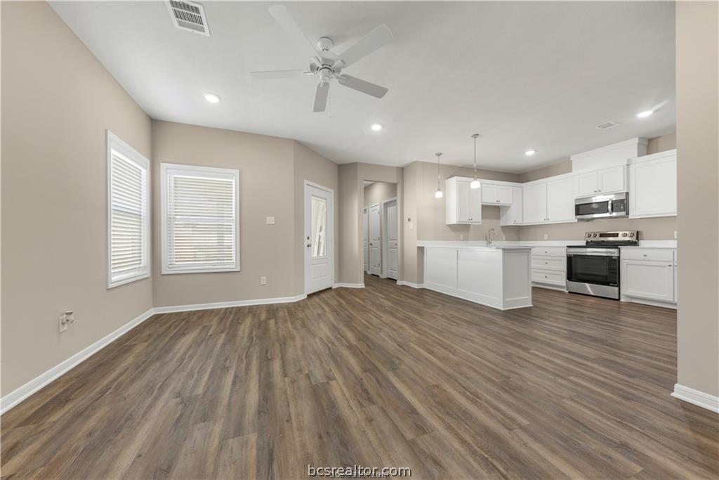 1249 Storm Row Lane Bryan, TX 77803 - Photo 3 of 20 a view of kitchen with wooden floor and window