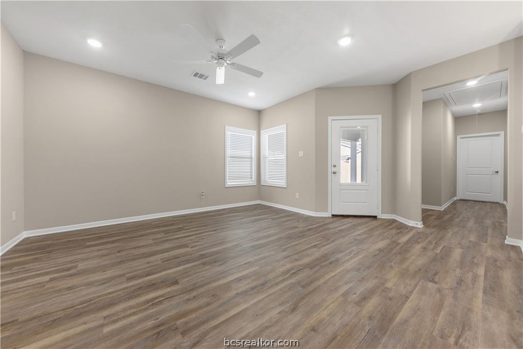 1249 Storm Row Lane Bryan, TX 77803 - Photo 4 of 20 a view of an empty room with window and wooden floor