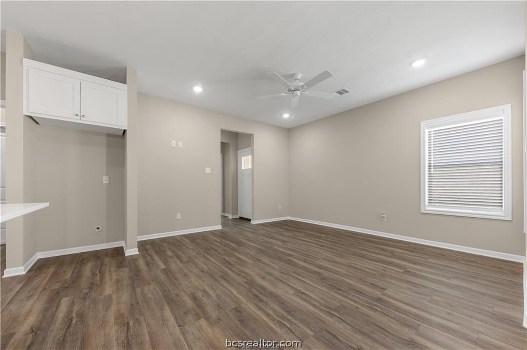1249 Storm Row Lane Bryan, TX 77803 - Photo 5 of 20 an empty room with wooden floor and windows