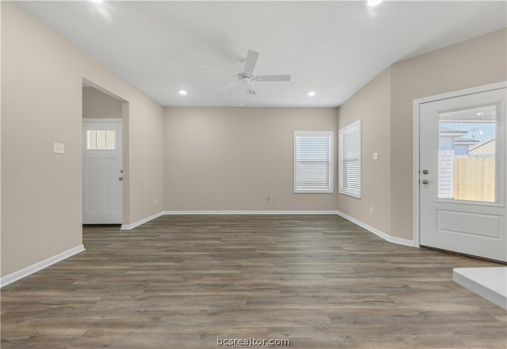 1249 Storm Row Lane Bryan, TX 77803 - Photo 10 of 20 a view of an empty room with wooden floor and window