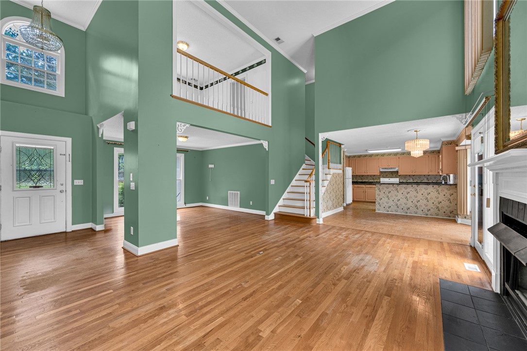 1016 Campbell Road Belton, SC 29627 - Photo 8 of 50 A spacious interior showcasing soaring ceilings and rich hardwood flooring, inviting natural light.