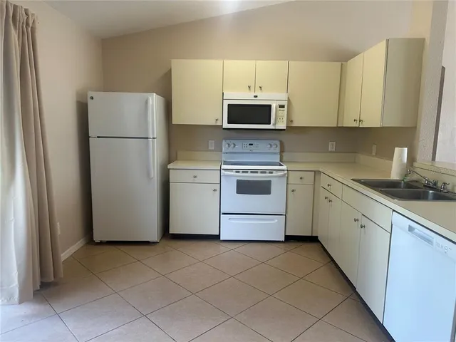 a kitchen with a refrigerator sink and microwave