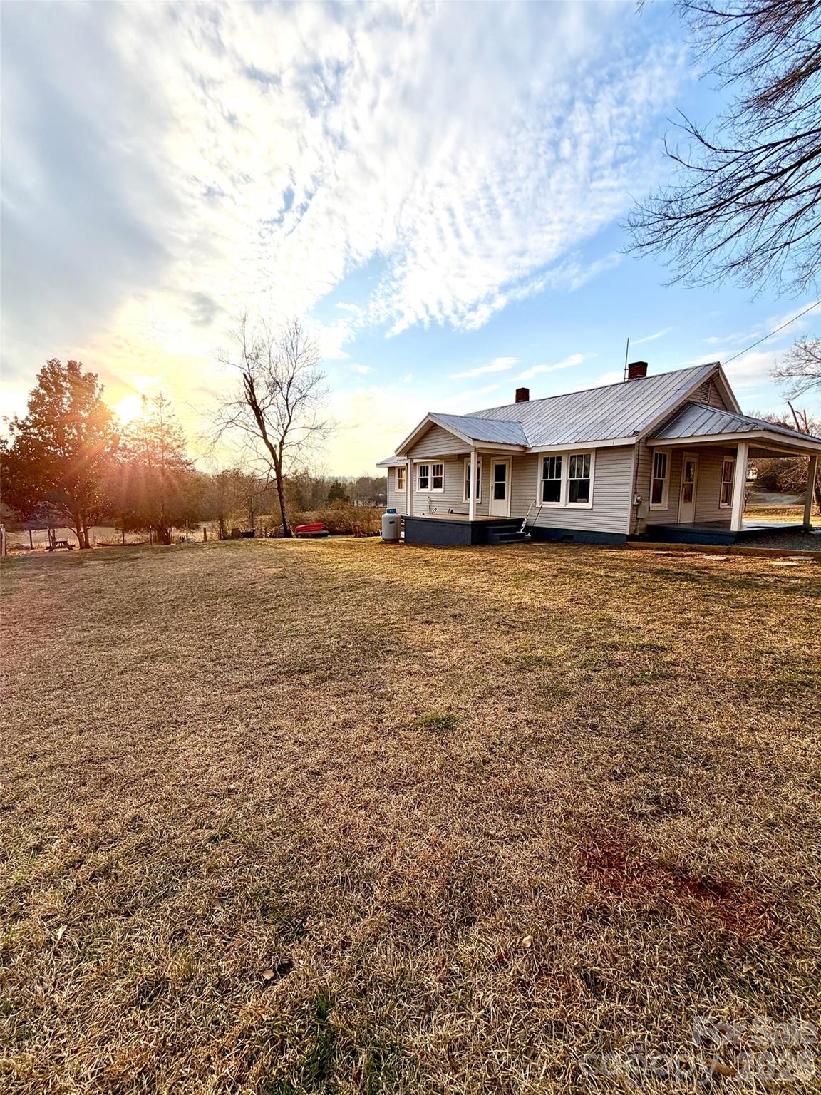 a view of a house next to a yard with an outdoor seating