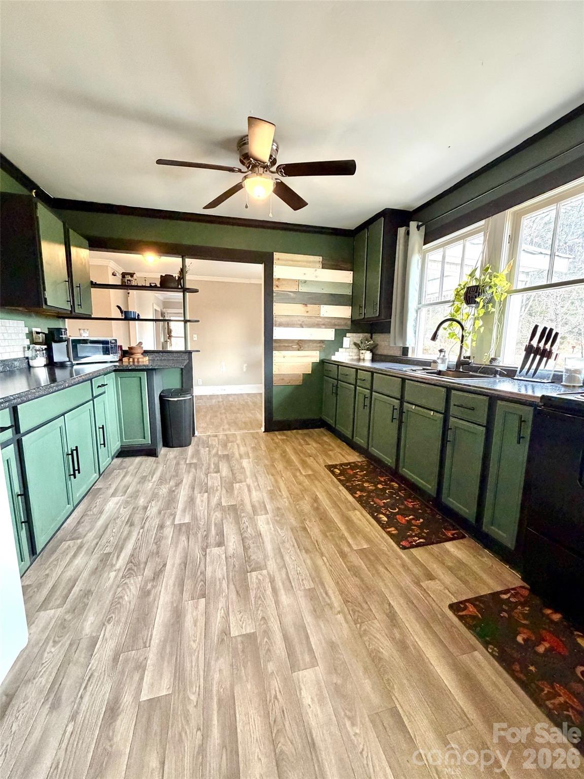 137 Clements Road Rutherfordton, NC 28139 - Photo 5 of 16 a kitchen with stainless steel appliances kitchen island granite countertop a sink and wooden cabinets