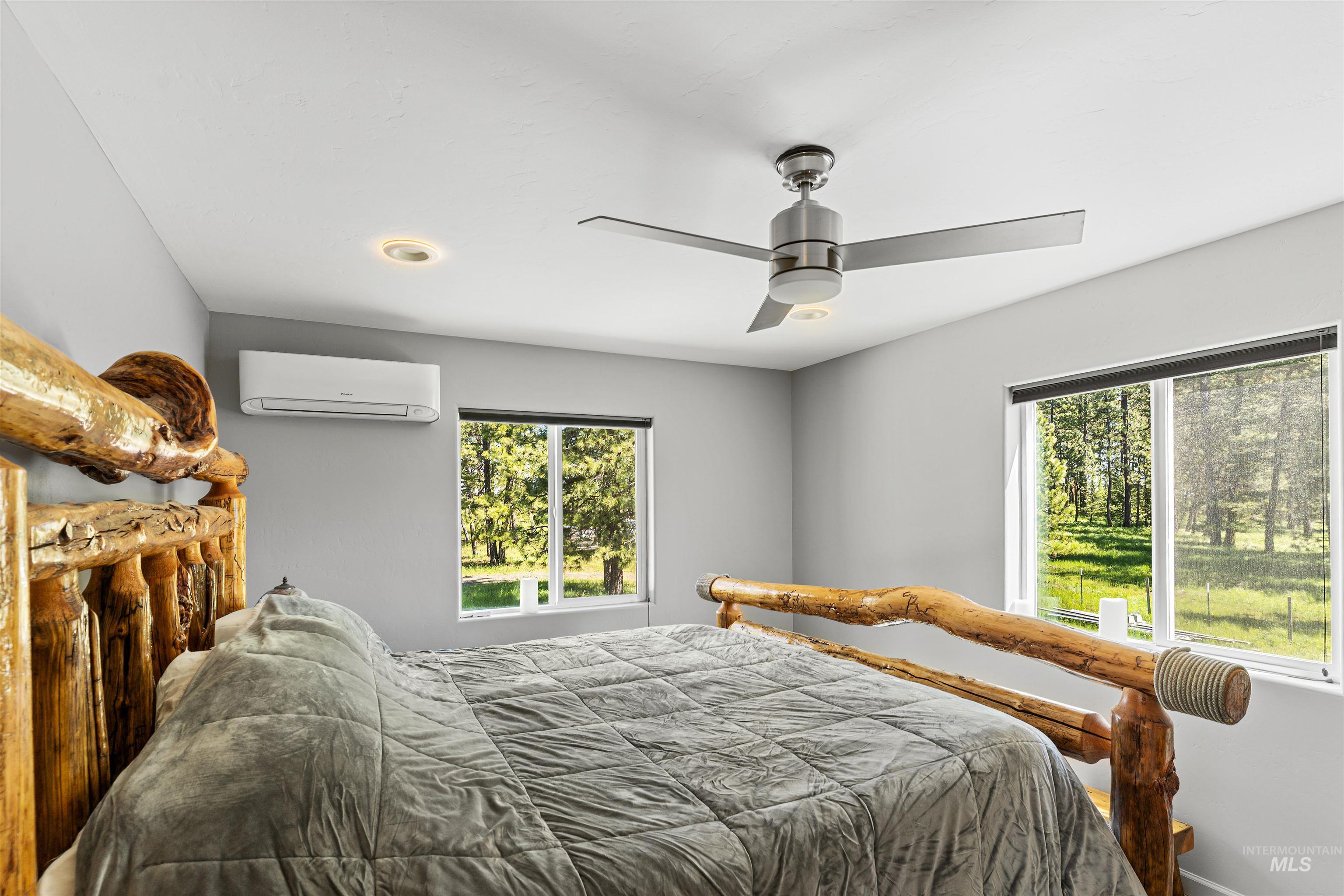 507 Bearlea Road Anatone, WA 99401 - Photo 14 of 47 Spacious room featuring light gray walls and two windows overlooking a natural landscape