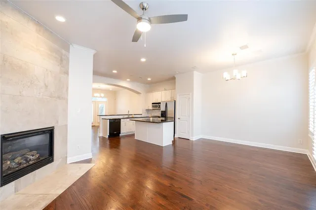 a view of kitchen with kitchen island wooden floor center island and appliances