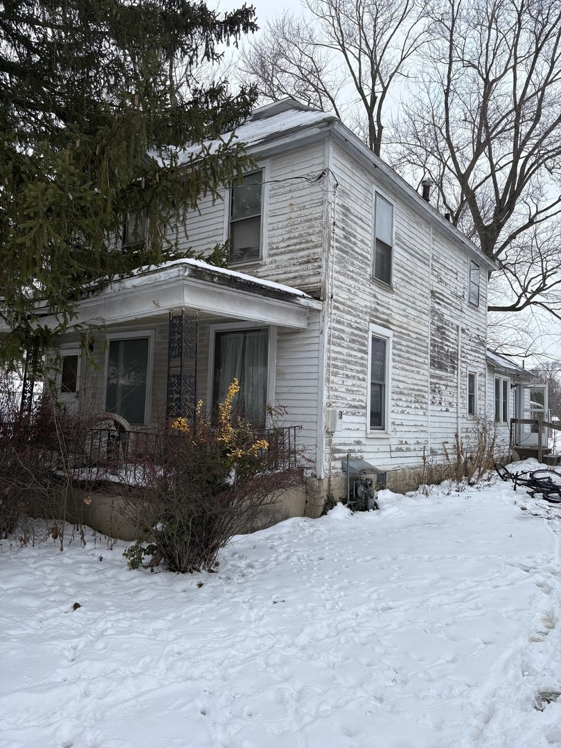 a front view of house with yard outdoor seating and barbeque oven