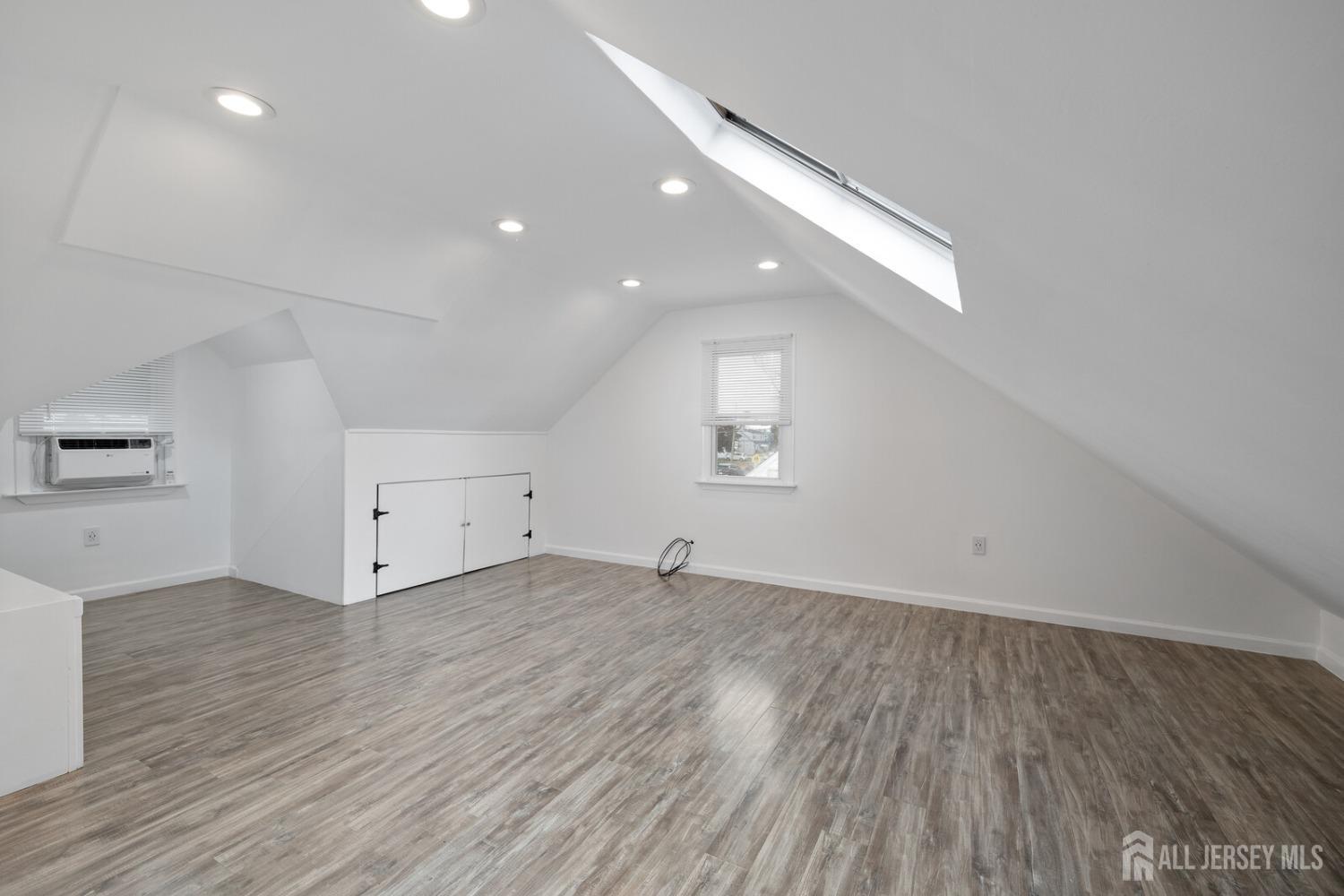 185 Plainfield Avenue Edison, NJ 08817 - Photo 18 of 30 an empty room with wooden floor and windows