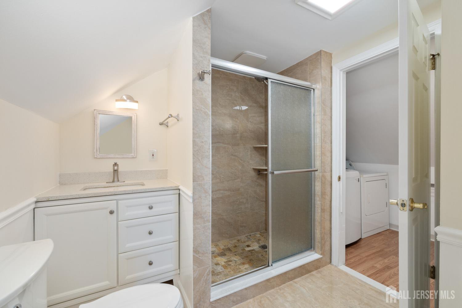 185 Plainfield Avenue Edison, NJ 08817 - Photo 21 of 30 a bathroom with a shower sink vanity and mirror