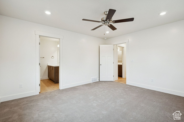 1615 North Angel Street, Unit E Layton, UT 84041 - Photo 23 of 42 Unfurnished bedroom with ensuite bathroom, recessed lighting, light carpet, and ceiling fan