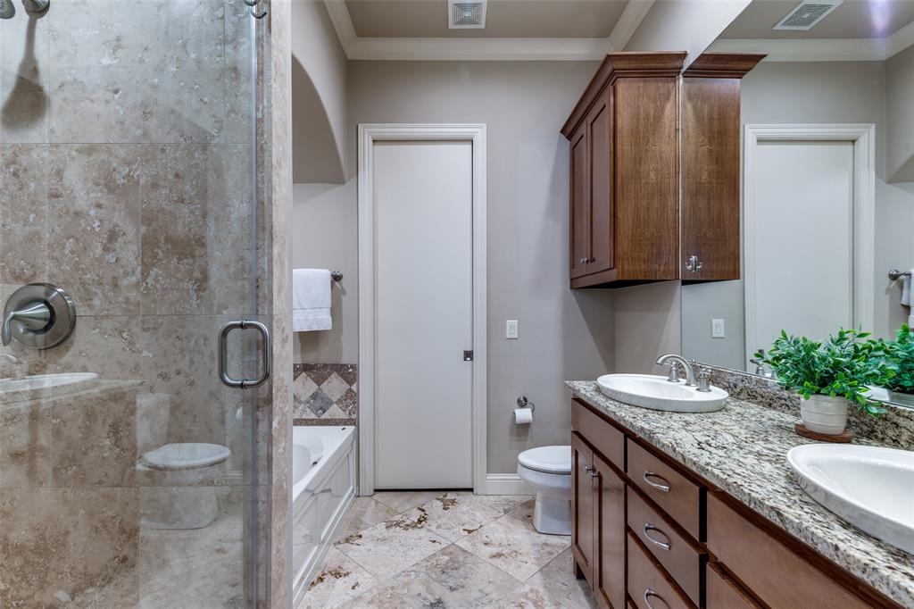 14725 Stanford Court Addison, TX 75254 - Photo 11 of 25 a bathroom with a granite countertop sink a toilet and shower