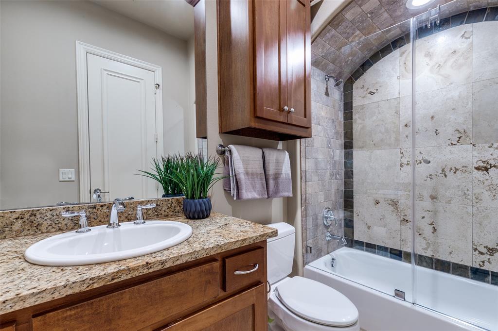 14725 Stanford Court Addison, TX 75254 - Photo 14 of 25 a bathroom with a granite countertop sink toilet and shower