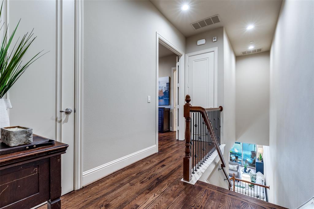 14725 Stanford Court Addison, TX 75254 - Photo 15 of 25 a view of a hallway with wooden floor and staircase