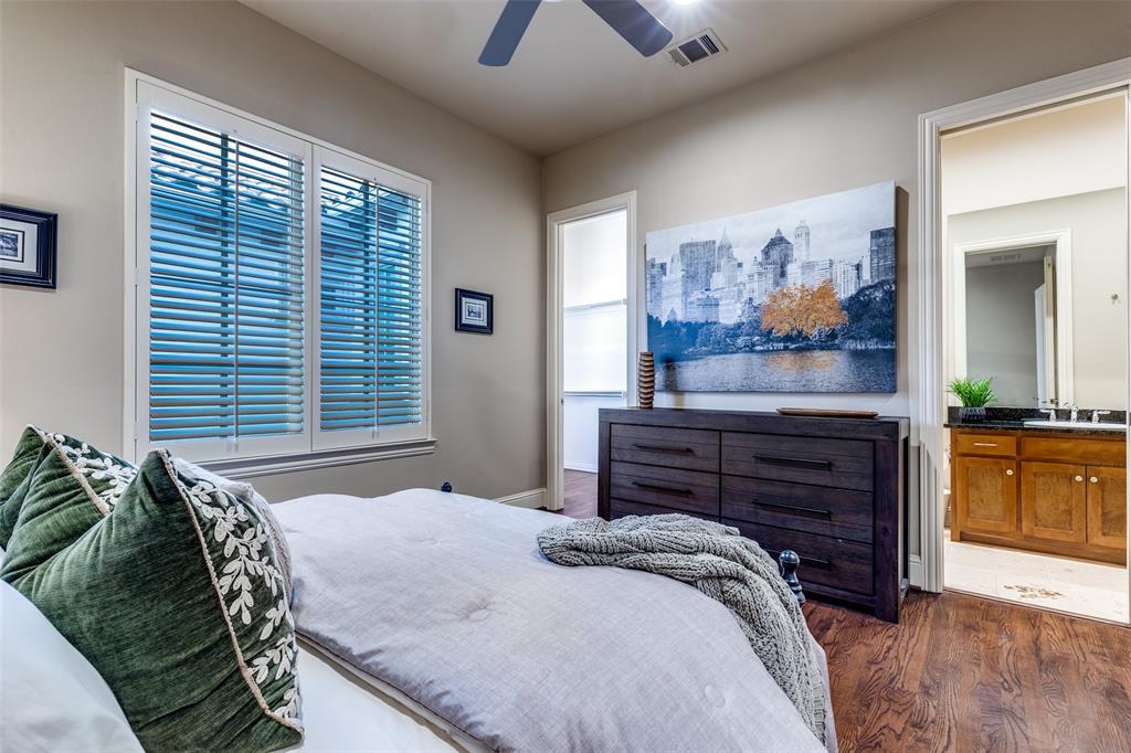 14725 Stanford Court Addison, TX 75254 - Photo 16 of 25 a bedroom with a bed and a chandelier