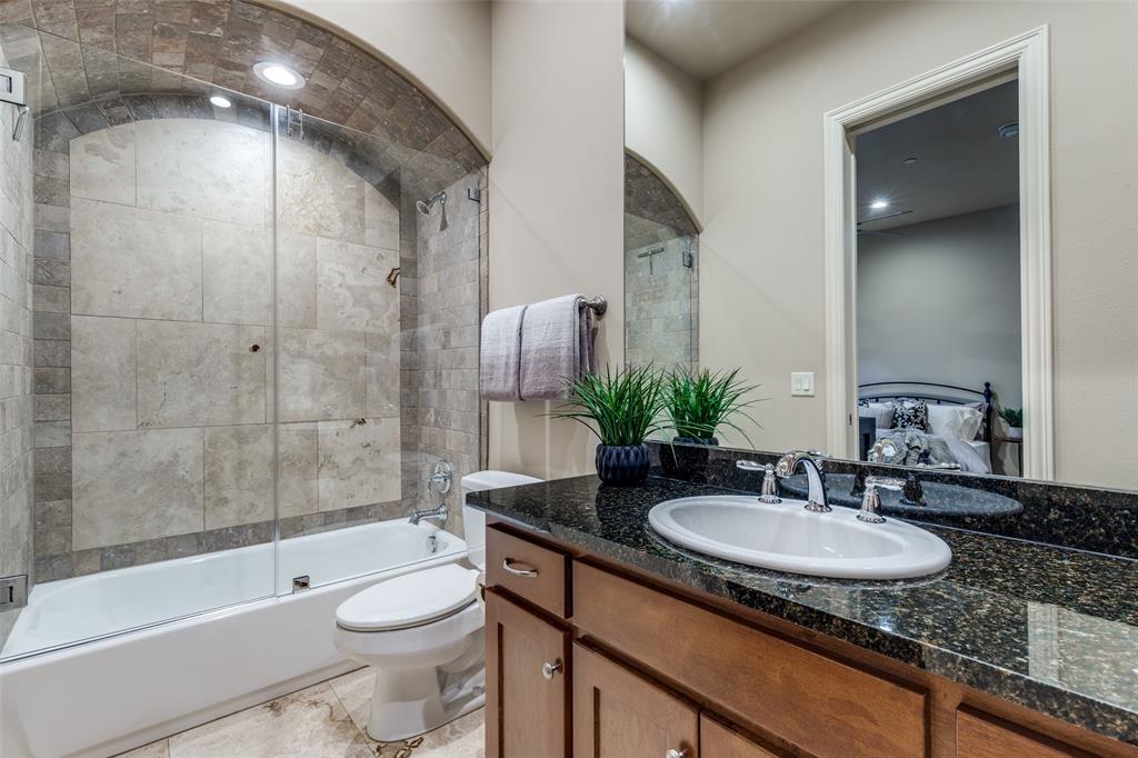 14725 Stanford Court Addison, TX 75254 - Photo 18 of 25 a bathroom with a granite countertop sink toilet and shower