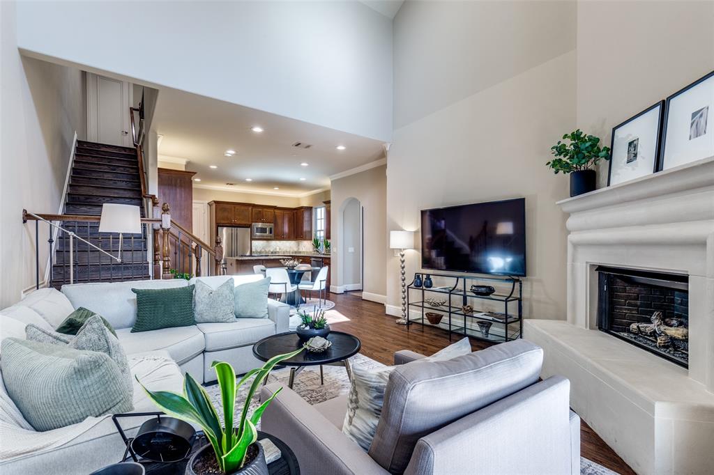 14725 Stanford Court Addison, TX 75254 - Photo 2 of 25 a living room with furniture a flat screen tv and a fireplace