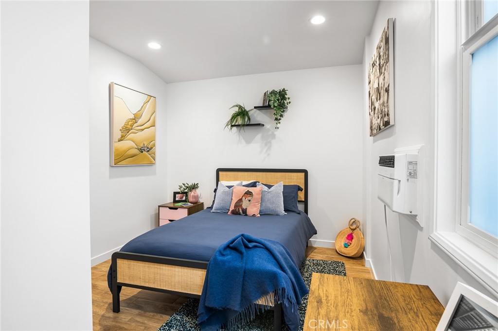 736 Griffith Place Laguna Beach, CA 92651 - Photo 22 of 24 a bedroom with a bed and wooden floor