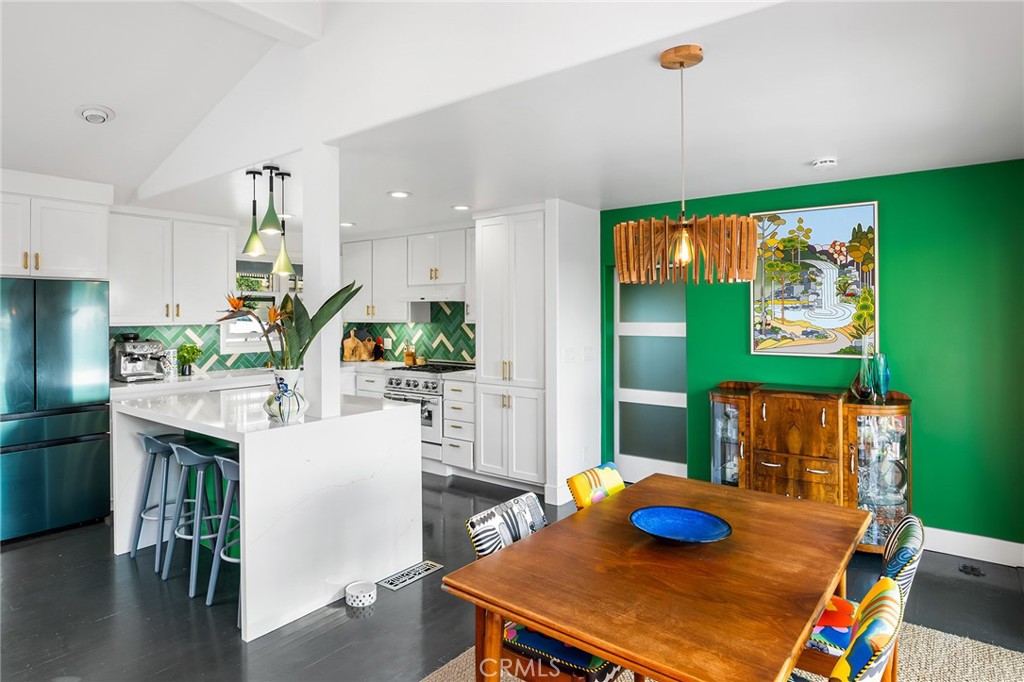 736 Griffith Place Laguna Beach, CA 92651 - Photo 4 of 24 a kitchen with stainless steel appliances kitchen island granite countertop a table chairs and a wooden floor