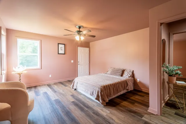 a bedroom with a bed and a chandelier