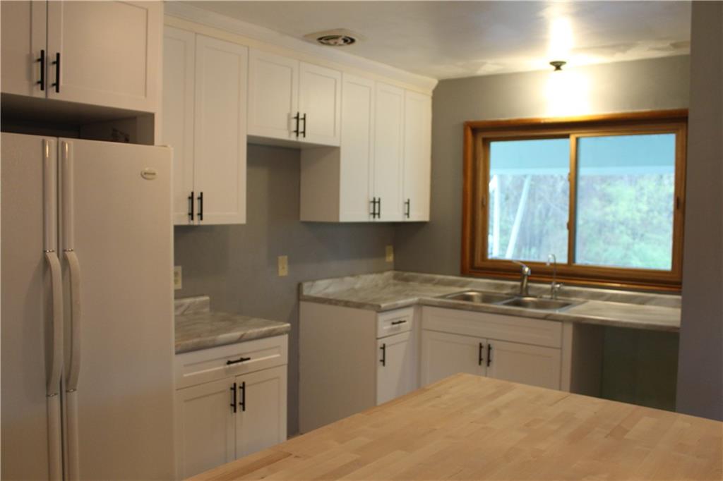 1287 Franklin Road Jackson Center, PA 16133 - Photo 2 of 21 a kitchen with a sink stove and refrigerator
