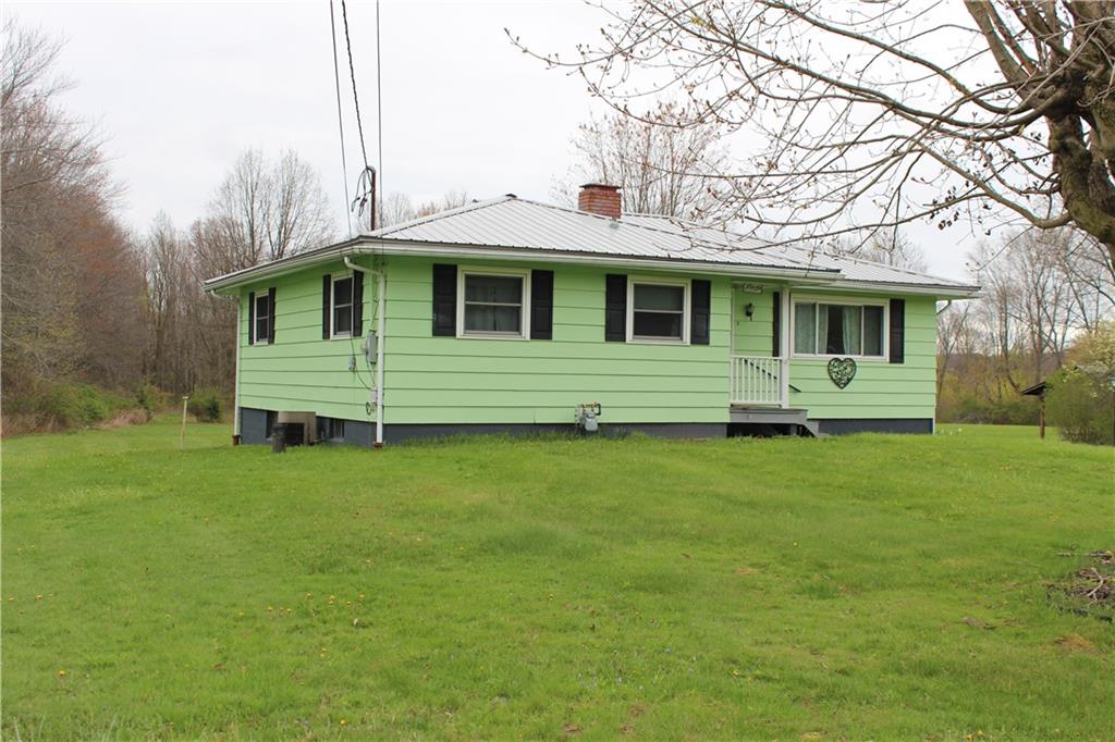 1287 Franklin Road Jackson Center, PA 16133 - Photo 21 of 21 a front view of a house with a garden