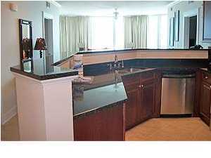 1110 Santa Rosa Boulevard, Unit B100 Fort Walton Beach, FL 32548 - Photo 12 of 27 a kitchen with a sink refrigerator and window