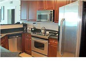 1110 Santa Rosa Boulevard, Unit B100 Fort Walton Beach, FL 32548 - Photo 13 of 27 a kitchen with stainless steel appliances granite countertop a stove a refrigerator and a sink