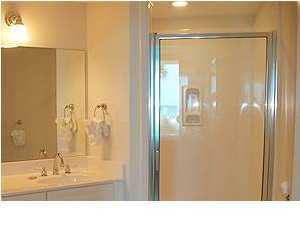 1110 Santa Rosa Boulevard, Unit B100 Fort Walton Beach, FL 32548 - Photo 23 of 27 a bathroom with a glass shower door