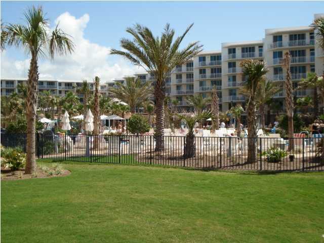1110 Santa Rosa Boulevard, Unit B100 Fort Walton Beach, FL 32548 - Photo 5 of 27 a view of a apartment with a yard and palm trees