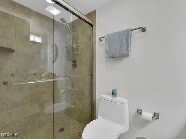 a white toilet sitting next to a bathroom sink