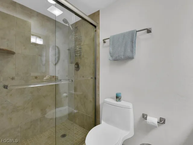 a white toilet sitting next to a bathroom sink