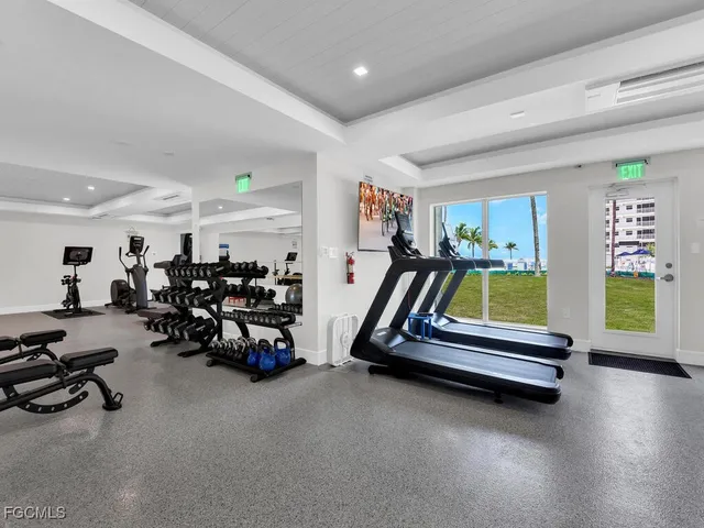 a room with gym equipment and lots of gym equipment
